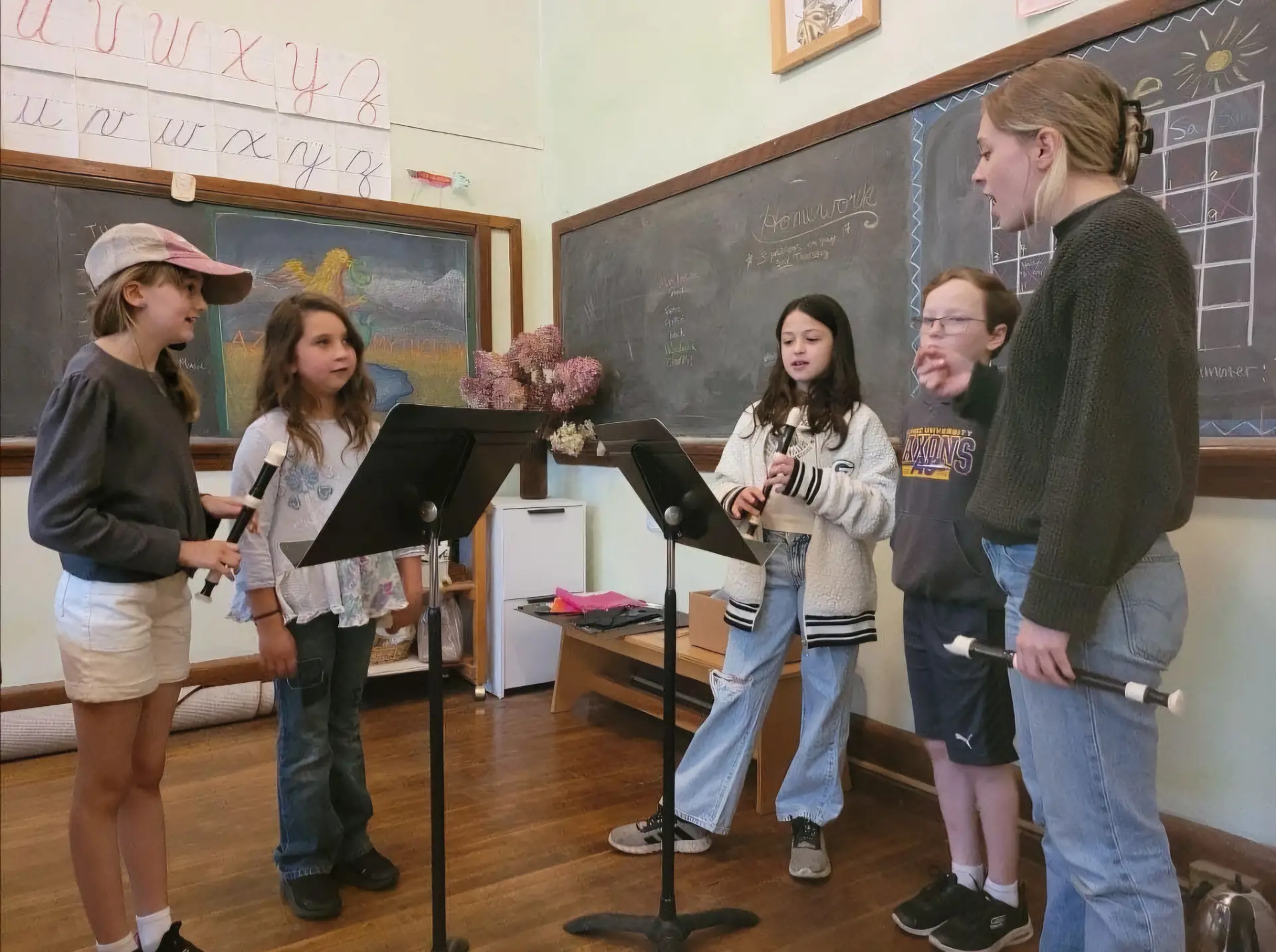 Recorder ensemble practicing with music stands