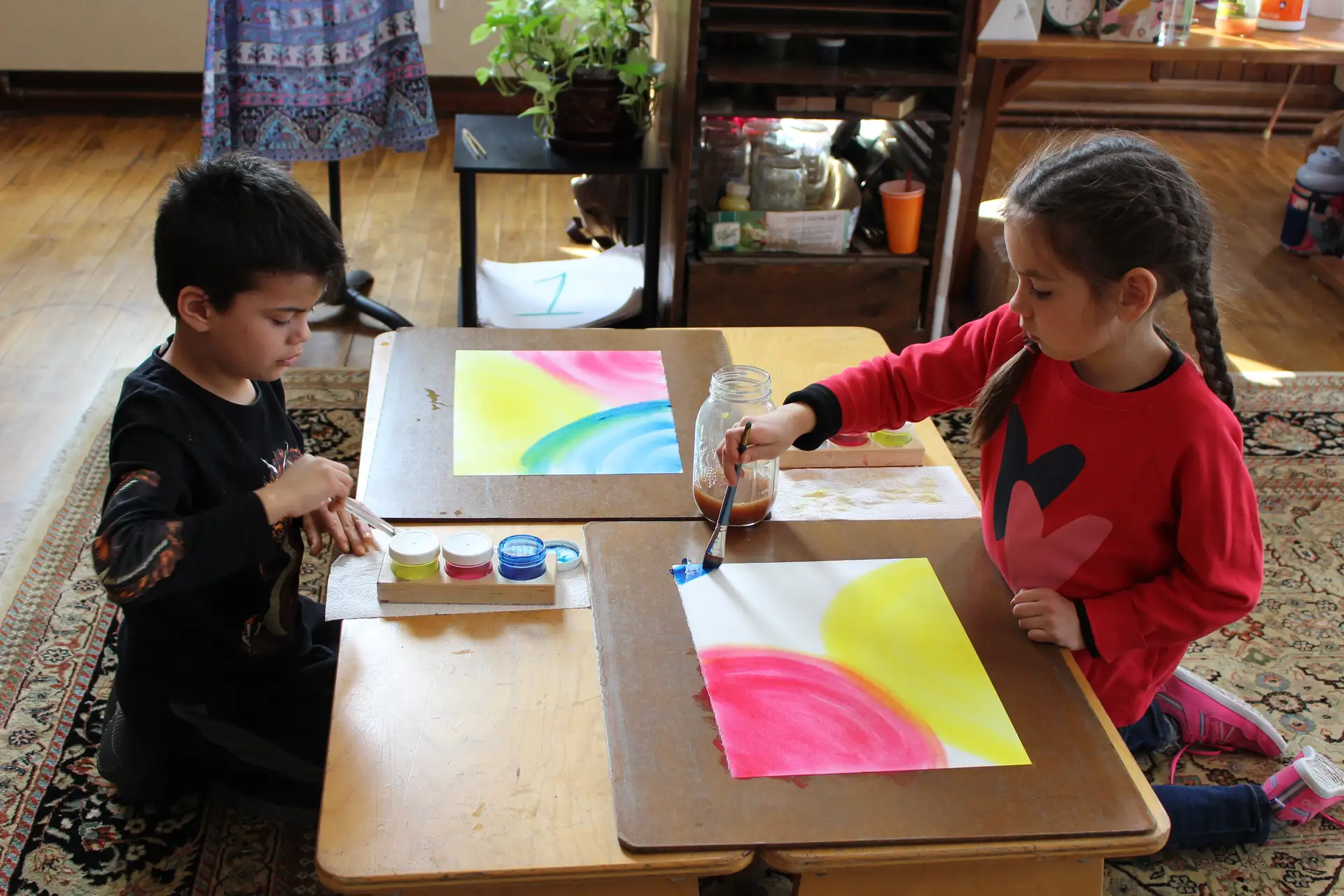 Student creating a wet-on-wet watercolor painting