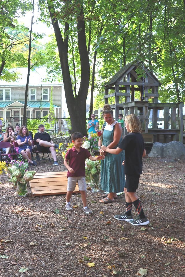 Students running an outdoor booth at a harvest fair
