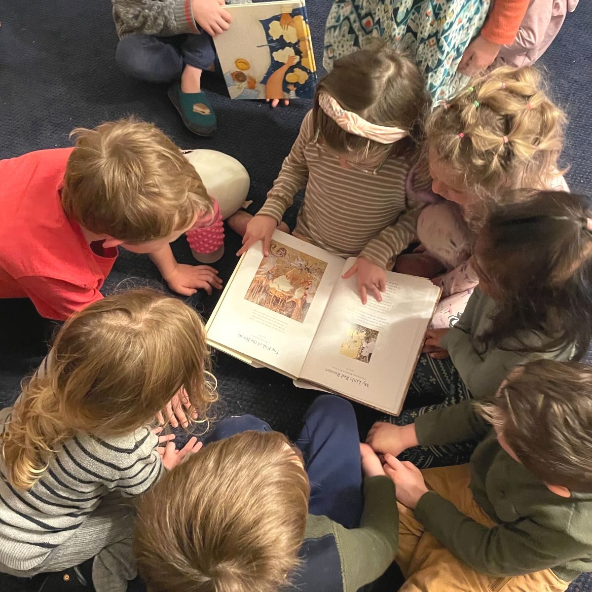 Young children looking through picture books together