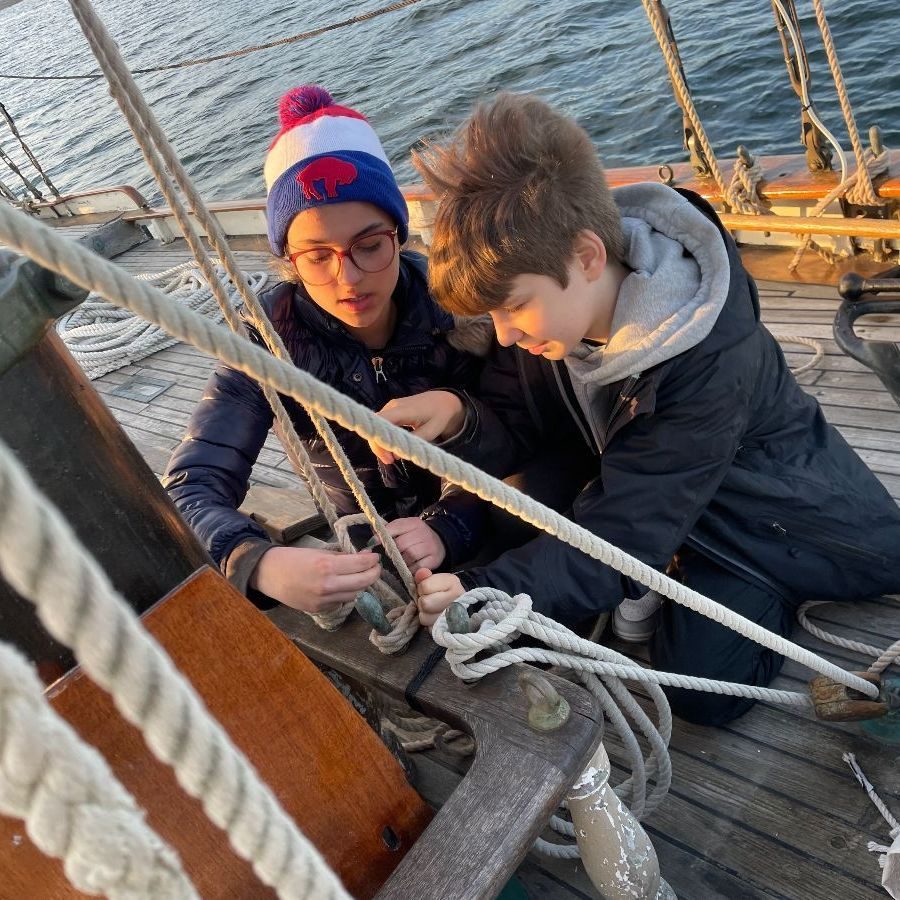 Seventh graders handling the rigging aboard a sailboat in Maine