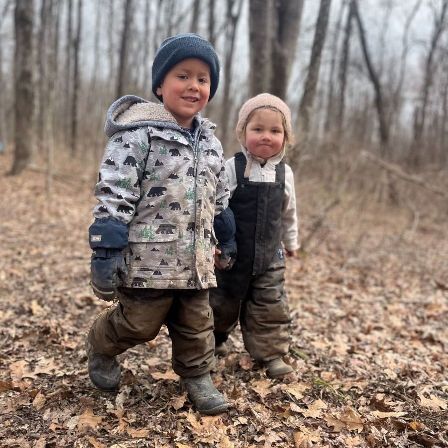 Two young students exploring the autumn woods