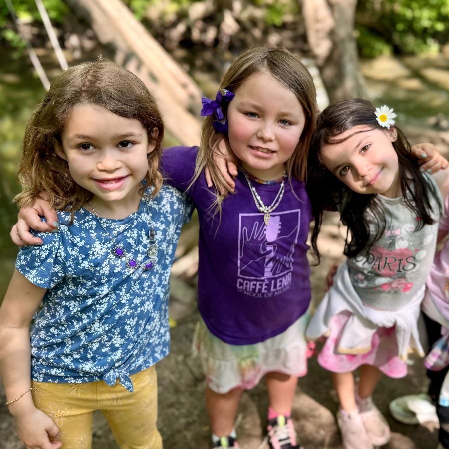 Three smiling students outdoors